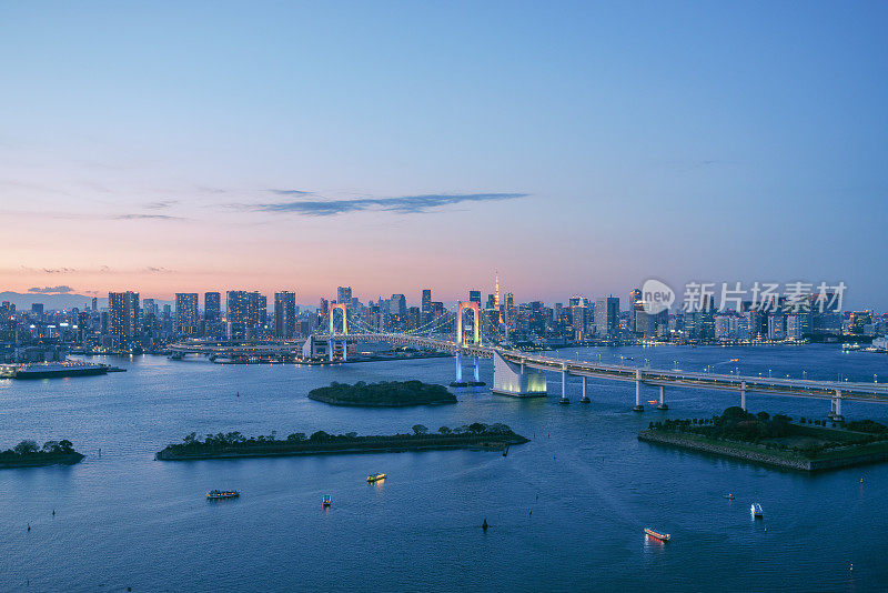 Tokyo Rainbow Bridge soaring over harbour bay futuristic cityscape Japan